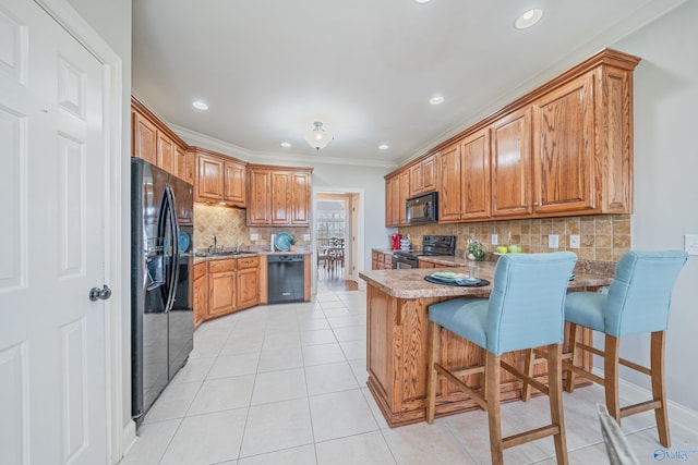 26409 Pepper Rd, Athens, AL 35613 - kitchen with light tile patterned flooring, black appliances, a peninsula, and brown cabinets