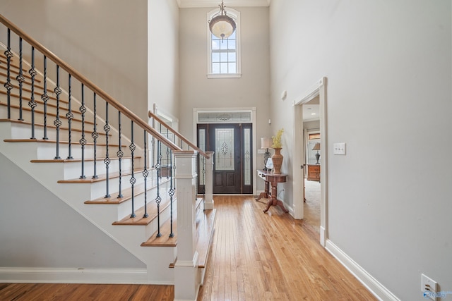 26409 Pepper Rd, Athens, AL 35613 - foyer entrance featuring a high ceiling, baseboards, wood finished floors, and stairway