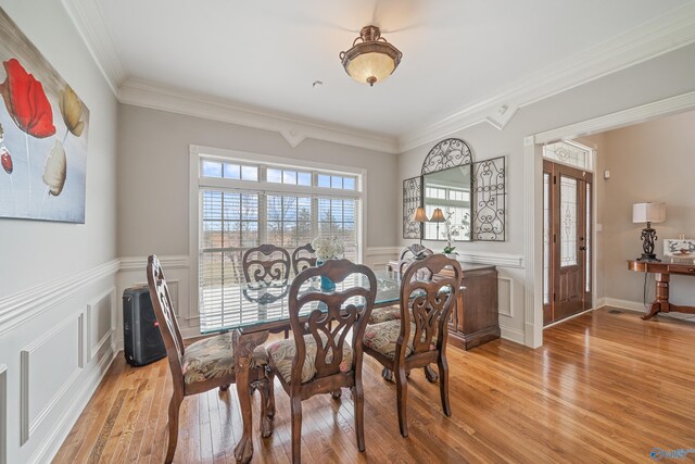 26409 Pepper Rd, Athens, AL 35613 - dining area featuring wainscoting, crown molding, and light wood-style flooring