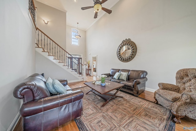 26409 Pepper Rd, Athens, AL 35613 - living room featuring stairs, high vaulted ceiling, baseboards, ceiling fan, and wood finished floors