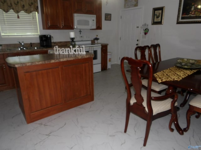 784 County Road 33, Fyffe, AL 35971 - kitchen with white appliances, a sink, light marble finish flooring, and a center island