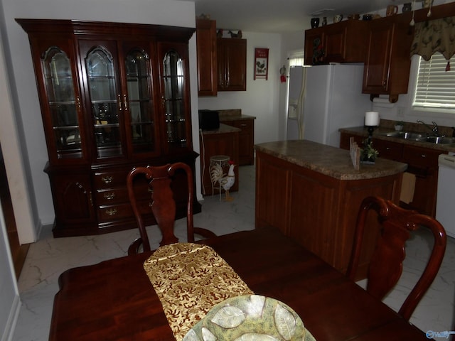 784 County Road 33, Fyffe, AL 35971 - kitchen featuring a sink, white fridge with ice dispenser, light marble finish floors, and a kitchen island