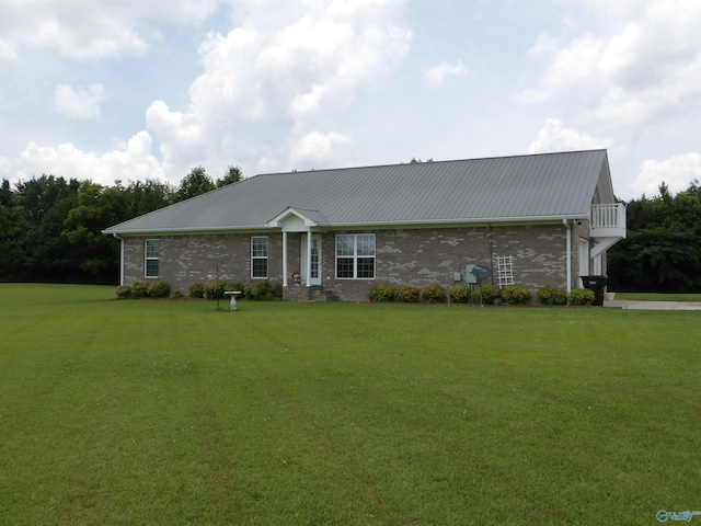 784 County Road 33, Fyffe, AL 35971 - view of front of home with metal roof, a front yard, and brick siding
