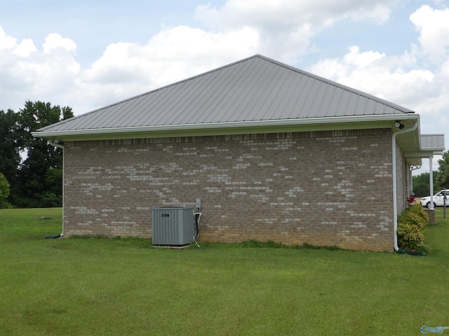 784 County Road 33, Fyffe, AL 35971 - view of side of property featuring central AC unit, a yard, brick siding, and metal roof