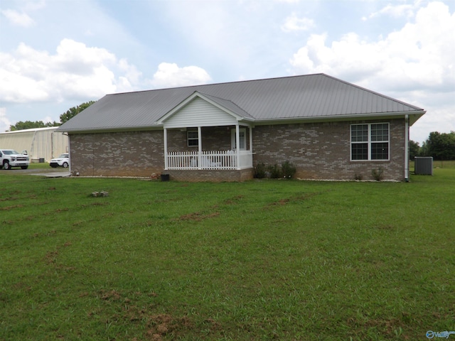 784 County Road 33, Fyffe, AL 35971 - view of front of house with brick siding, central air condition unit, a front lawn, and metal roof