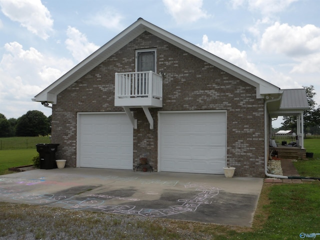 784 County Road 33, Fyffe, AL 35971 - view of property exterior featuring a balcony, an attached garage, driveway, and brick siding
