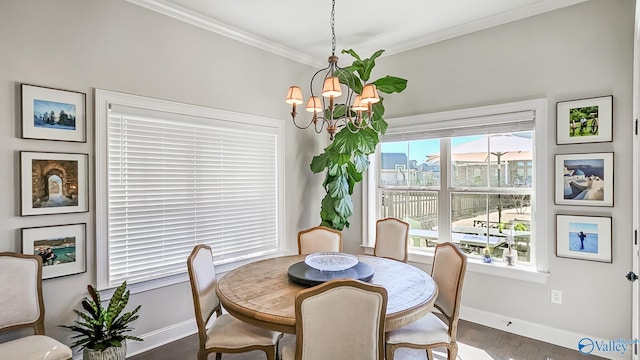 dining space featuring baseboards, an inviting chandelier, ornamental molding, and dark wood finished floors