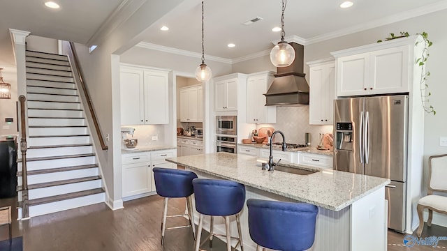 kitchen with dark wood-style flooring, white cabinetry, stainless steel appliances, and a sink