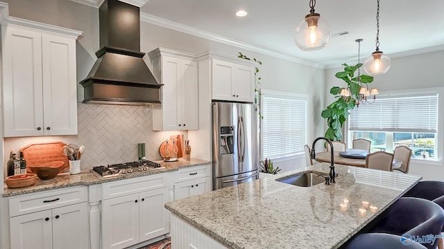 kitchen featuring a sink, appliances with stainless steel finishes, crown molding, and premium range hood