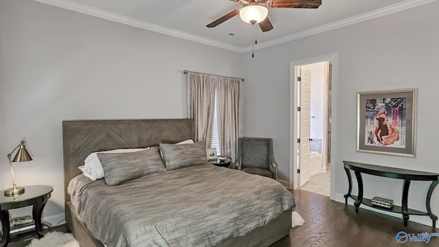 bedroom with wood finished floors, baseboards, visible vents, ornamental molding, and ensuite bathroom