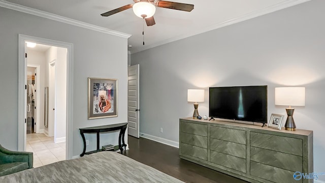 bedroom with baseboards, wood finished floors, and crown molding