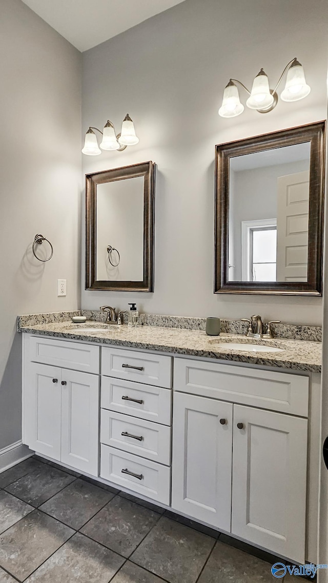 full bath with double vanity and a sink