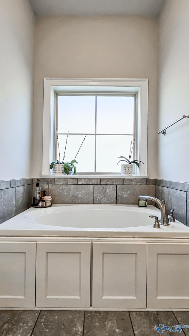 full bath featuring a wealth of natural light and a garden tub