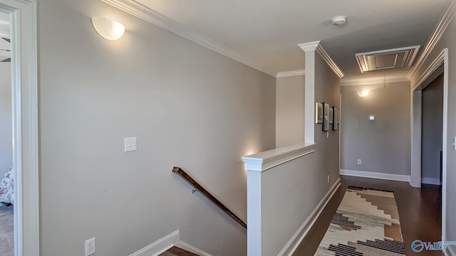 corridor featuring attic access, crown molding, an upstairs landing, and baseboards