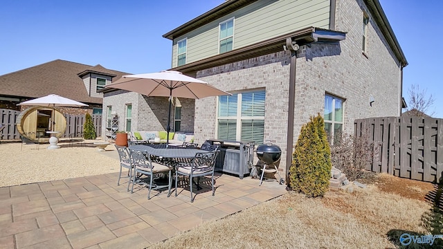 view of patio featuring area for grilling and fence