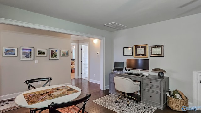 office space featuring visible vents, baseboards, and dark wood-type flooring