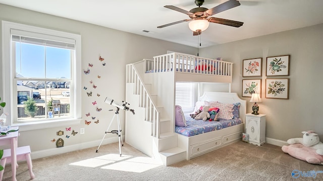 carpeted bedroom with visible vents, multiple windows, and baseboards