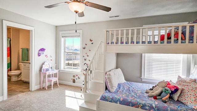 bedroom featuring carpet flooring, multiple windows, baseboards, and visible vents