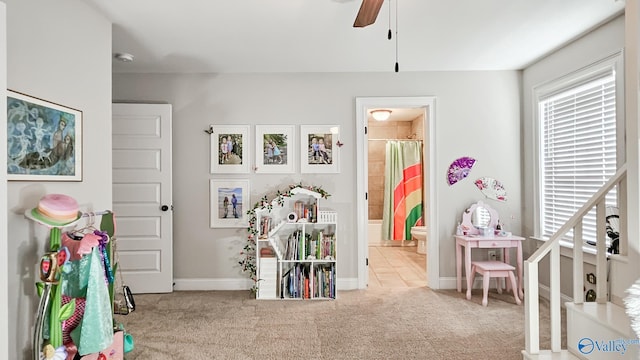 recreation room featuring baseboards, plenty of natural light, ceiling fan, and carpet flooring