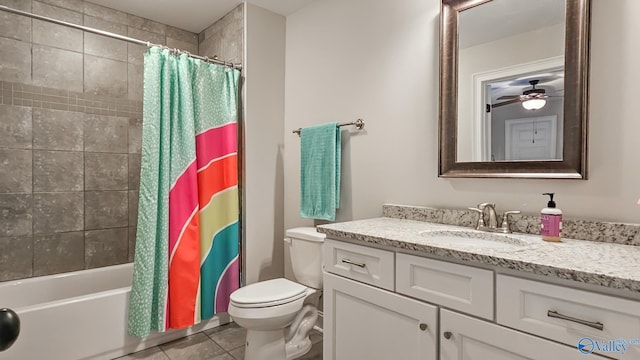 full bathroom featuring vanity, a ceiling fan, shower / bath combo with shower curtain, tile patterned floors, and toilet