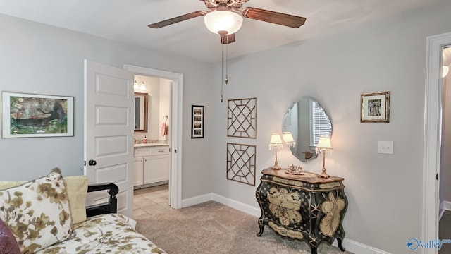 living area with light carpet, ceiling fan, and baseboards