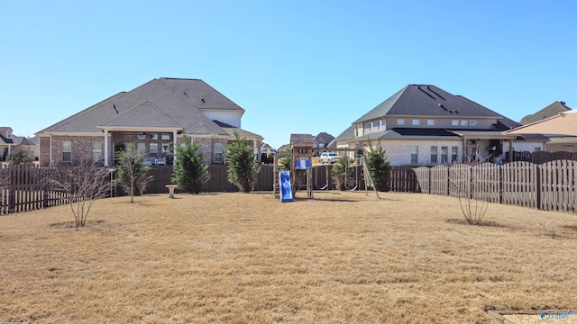 view of yard featuring a playground and a fenced backyard