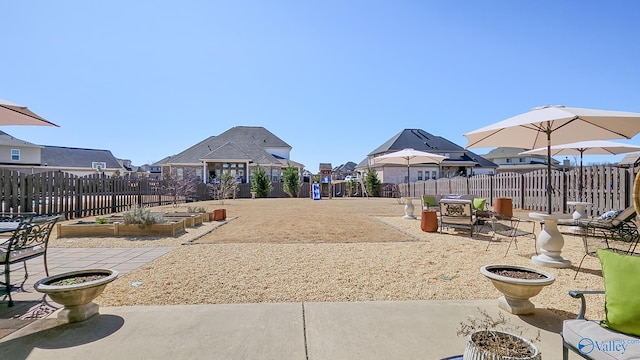 surrounding community featuring a patio area, a garden, fence, and a residential view