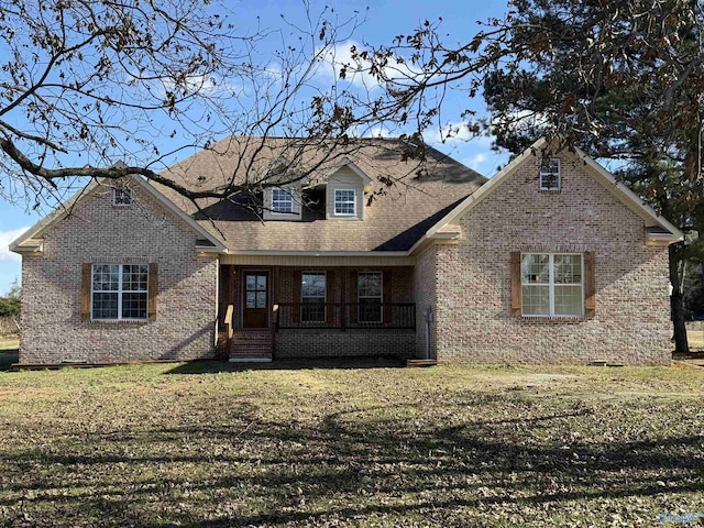 view of front of home with covered porch and a front yard