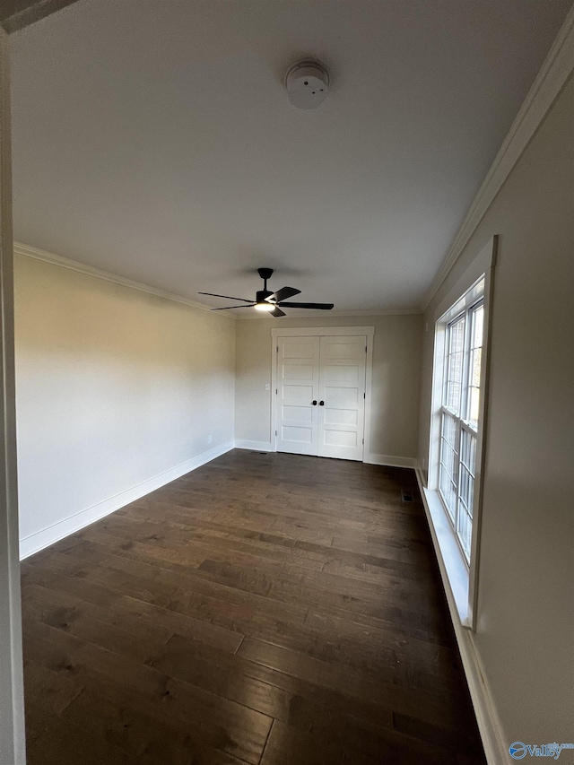 spare room with ceiling fan, dark hardwood / wood-style floors, and ornamental molding