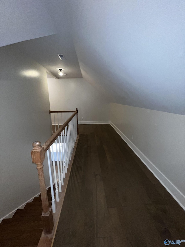 stairs with wood-type flooring and lofted ceiling