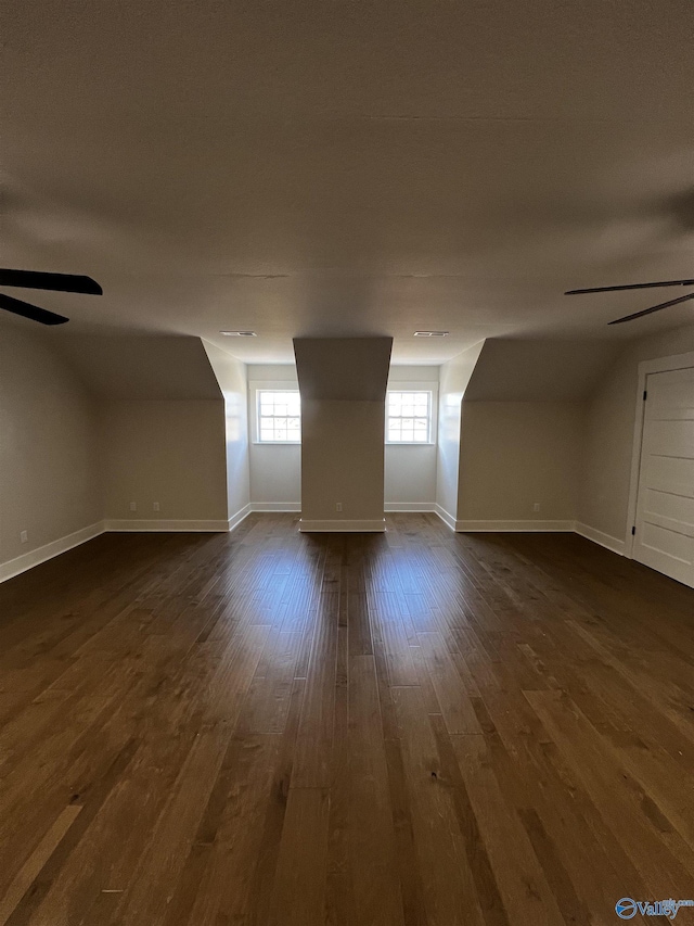 bonus room featuring dark hardwood / wood-style flooring, ceiling fan, and lofted ceiling