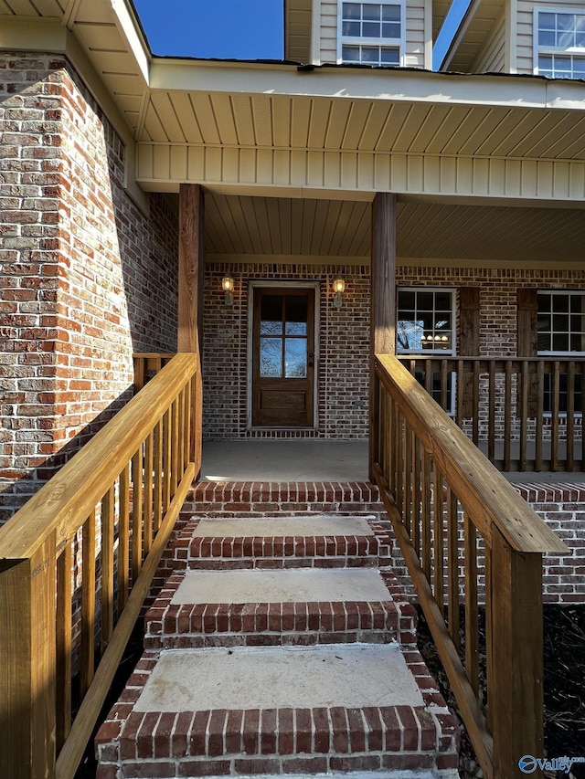 view of exterior entry with covered porch