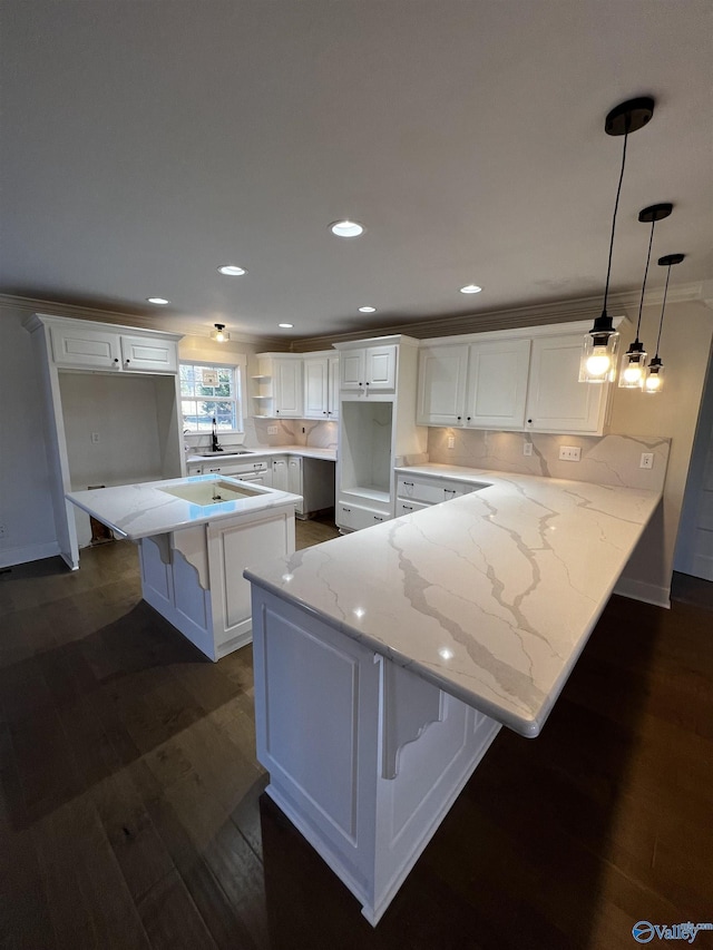 kitchen featuring white cabinetry, dark hardwood / wood-style floors, and decorative light fixtures