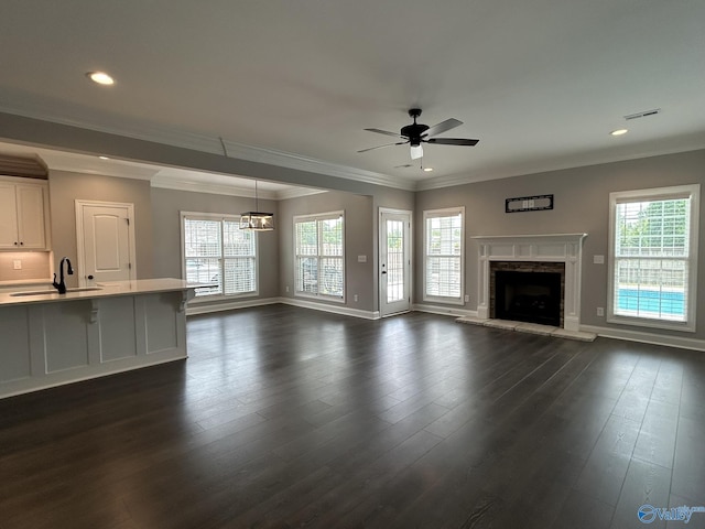 4359 Willow Bend Ln SE, Owens Cross Roads, AL 35763 - unfurnished living room featuring a stone fireplace, ceiling fan, dark wood-style flooring, ornamental molding, and recessed lighting