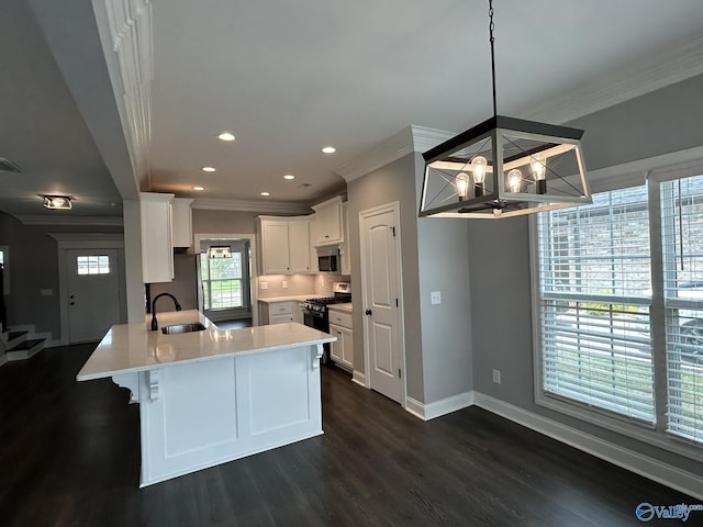 4359 Willow Bend Ln SE, Owens Cross Roads, AL 35763 - kitchen featuring ornamental molding, stainless steel microwave, a peninsula, range with gas stovetop, and dark wood-type flooring