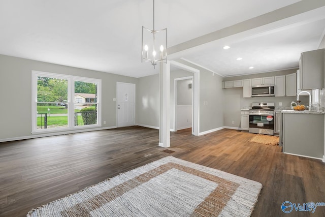 2017 Shady Lane Dr, Huntsville, AL 35810 - unfurnished living room with an inviting chandelier, sink, and dark hardwood / wood-style floors