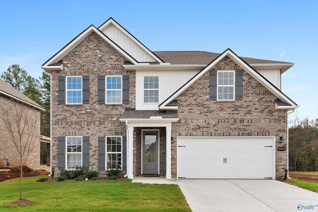 craftsman-style house featuring a garage, central air condition unit, and a front yard