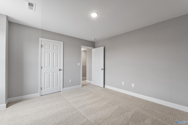 unfurnished bedroom featuring light carpet