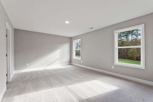 empty room with plenty of natural light and light colored carpet