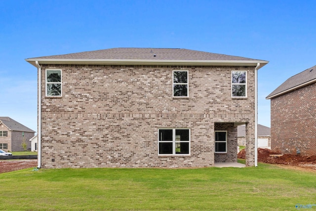 back of property featuring a yard