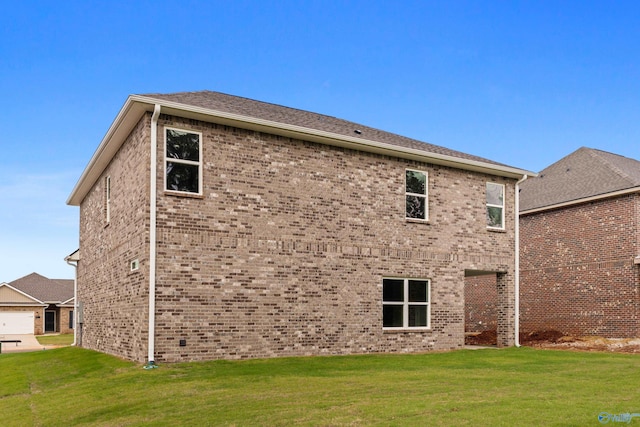 rear view of house with a yard