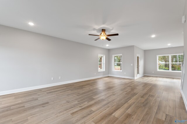 unfurnished living room with a fireplace, ceiling fan, and hardwood / wood-style floors