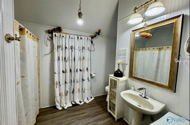 bathroom featuring a shower with curtain, hardwood / wood-style flooring, and toilet