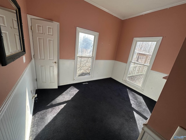 spare room featuring carpet and ornamental molding