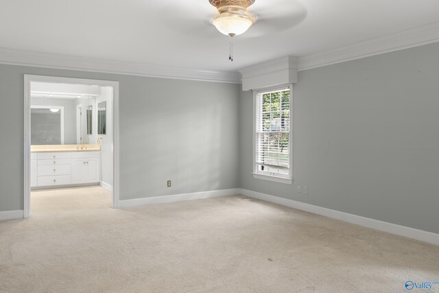 carpeted empty room with ceiling fan and ornamental molding