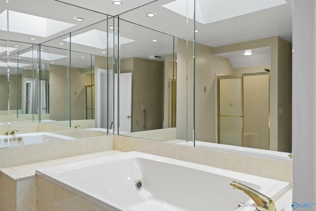 bathroom featuring plus walk in shower and a skylight