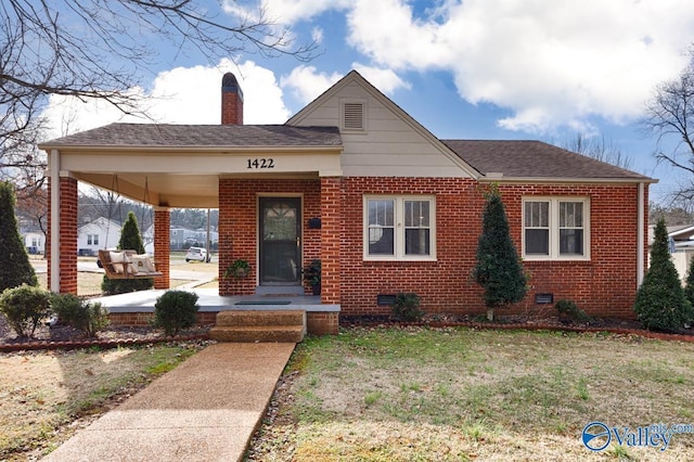 bungalow-style house with a front lawn