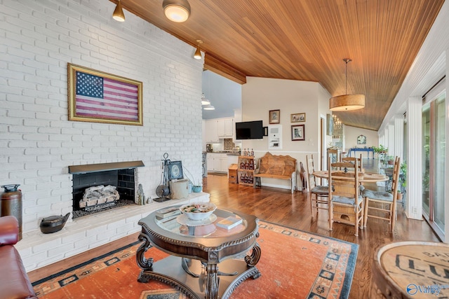 411 Darby Ave, Sheffield, AL 35660 - living room with lofted ceiling, wood finished floors, wood ceiling, and a brick fireplace