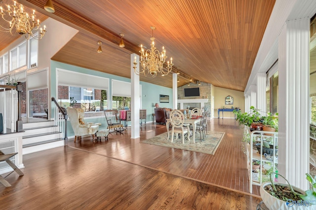 411 Darby Ave, Sheffield, AL 35660 - dining room with a chandelier, a fireplace, wood finished floors, lofted ceiling, and wood ceiling