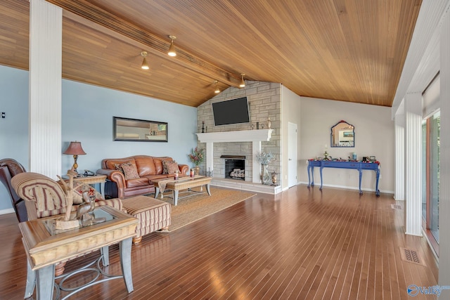 411 Darby Ave, Sheffield, AL 35660 - living area featuring lofted ceiling with beams, visible vents, wood finished floors, a stone fireplace, and wooden ceiling